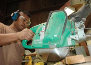 man using a radial arm saw